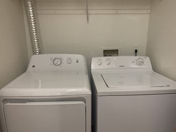 A laundry room with two washes and a dryer